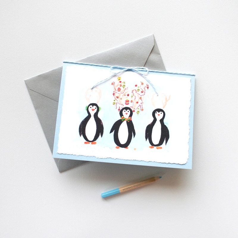 Handmade and hand-painted watercolor penguins Christmas card by artist Michelle Mospens. | Mospens Studio