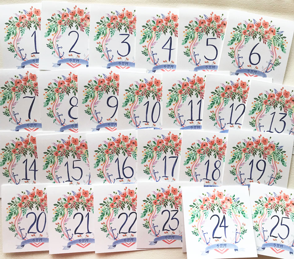 Hand painted nautical wedding crest table cards with hand drawn numbers by artist Michelle Mospens. // Mospens Studio