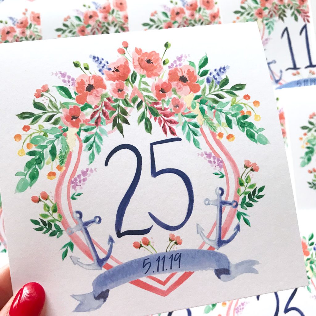 Hand painted nautical wedding crest table cards with hand drawn numbers by artist Michelle Mospens. // Mospens Studio