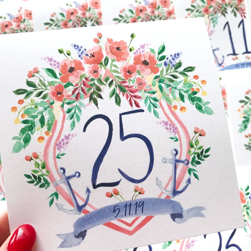 Hand painted watercolor nautical wedding crest table cards with hand drawn numbers by artist Michelle Mospens. // Mospens Studio