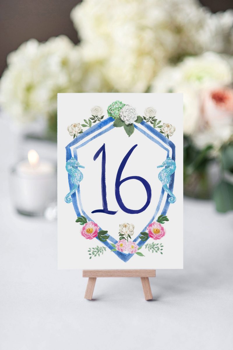 Beach Wedding table number cards with wedding crest and brush lettering numbers by artist Michelle Mospens. Mospens Studio