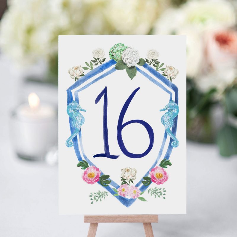 Beach Wedding table number cards with wedding crest and brush lettering numbers by artist Michelle Mospens. Mospens Studio